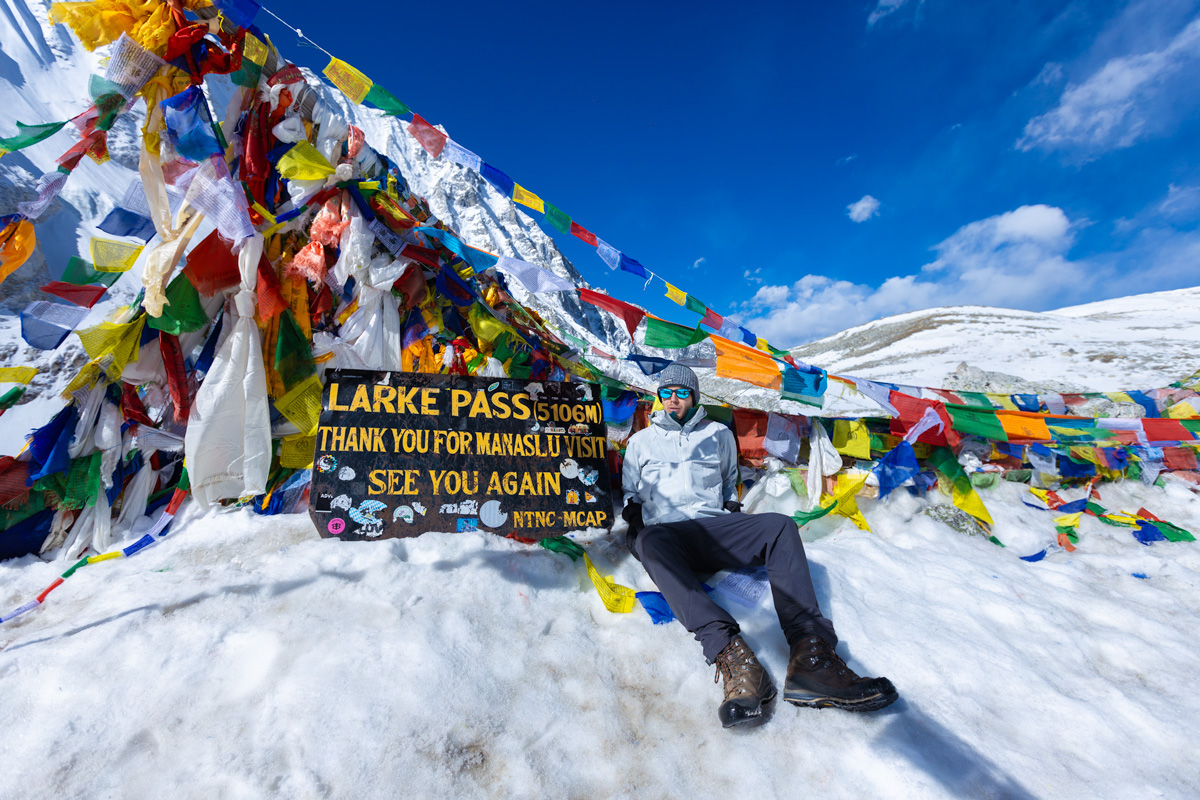 A Trekker taking Photo on the top of Larke Pass.