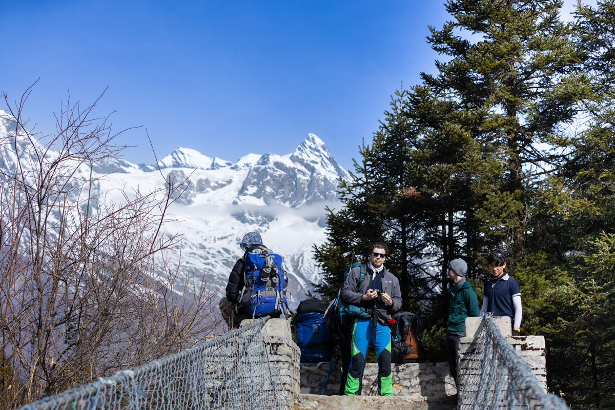 Hikers taking rest after crossing the bridge during manaslu Trek